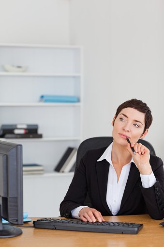 portrait of a secretary thinking in her office